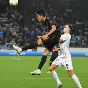 Arsenal's Tomiyasu Soars Over Zurich's Selnaes in Europa League Clash