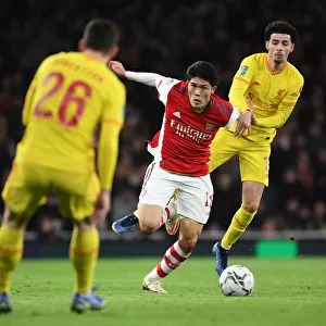 Arsenal's Tomiyasu Tackles Liverpool's Jones in Carabao Cup Semi-Final Showdown