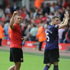 Arsenal's Triumph: Mertesacker, Podolski, and Vermaelen's Victory Dance (Liverpool 2012) Arsenal's Triumph: Mertesacker, Podolski, and Vermaelen's Victory Dance (Liverpool 2012)