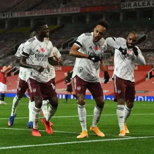 Arsenal's Triumphant Threesome: Aubameyang, Partey, Lacazette Celebrate Goal at Empty Old Trafford (2020-21) Arsenal's Triumphant Threesome: Aubameyang, Partey, Lacazette Celebrate Goal at Empty Old Trafford (2020-21)