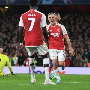 Arsenal's Trossard and Saka Celebrate First Goal vs Sevilla in 2023-24 Champions League