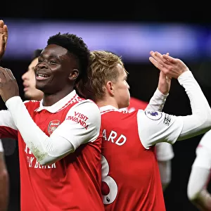 Arsenal's Unstoppable Duo: Martin Odegaard and Bukayo Saka Celebrate Goal Against Tottenham in the 2022-23 Premier League