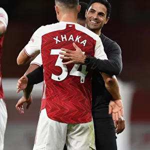 Arsenal's Victory: Mikel Arteta Embraces Granit Xhaka after Arsenal v West Ham United (2020-21)