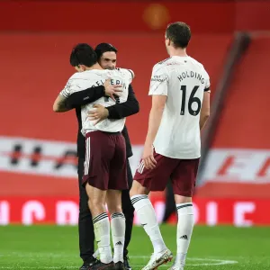 Arsenal's Victory at Old Trafford: Arteta and Bellerin Celebrate Amidst Empty Stands (Manchester United vs Arsenal, 2020-21) Arsenal's Victory at Old Trafford: Arteta and Bellerin Celebrate Amidst Empty Stands (Manchester United vs Arsenal, 2020-21)