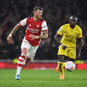 Arsenal's White Stands Firm Against Liverpool's Mane in Intense Premier League Clash