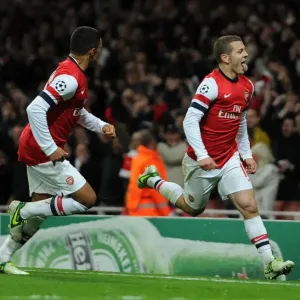 Arsenal's Wilshere and Oxlade-Chamberlain Celebrate Goal Against Montpellier (2012-13)
