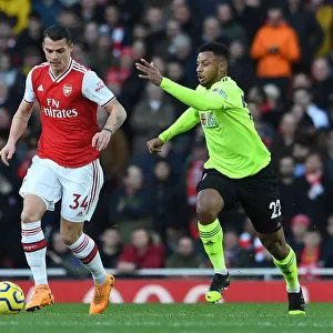 Arsenal's Xhaka Faces Pressure from Sheffield United's Mousset in Premier League Clash