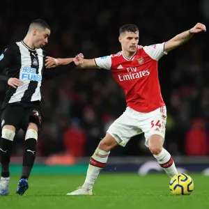 Arsenal's Xhaka Holds Off Newcastle's Almiron in Premier League Clash Arsenal's Xhaka Holds Off Newcastle's Almiron in Premier League Clash