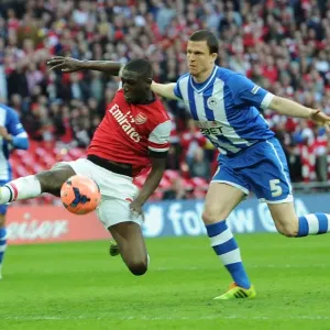 Arsenal's Yaya Sanogo Faces Off Against Wigan's Gary Cadwell in FA Cup Semi-Final Showdown Arsenal's Yaya Sanogo Faces Off Against Wigan's Gary Cadwell in FA Cup Semi-Final Showdown