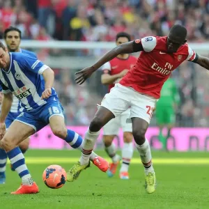 Arsenal's Yaya Sanogo vs. Wigan's James McArthur: A FA Cup Semi-Final Battle Arsenal's Yaya Sanogo vs. Wigan's James McArthur: A FA Cup Semi-Final Battle