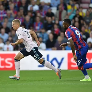 Arsenal's Zinchenko Outmaneuvers Crystal Palace's Ayew in Premier League Clash