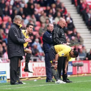 Arsene Wenger the Arsenal Manager brings on substitutes Ashley Cole and Robin van Persie