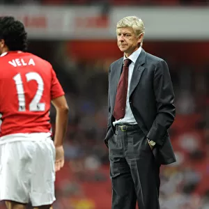 Arsene Wenger the Arsenal Manager with Carlos Vela