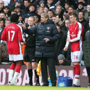 Arsene Wenger the Arsenal Manager gives Alex Song