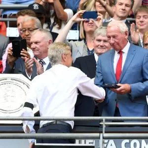Arsene Wenger the Arsenal Manager is handed his medal by Bob Wilson the former Arsenal Arsene Wenger the Arsenal Manager is handed his medal by Bob Wilson the former Arsenal