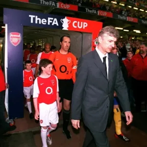 Arsene Wenger the Arsenal Manager leads to team out onto the pitch Arsene Wenger the Arsenal Manager leads to team out onto the pitch