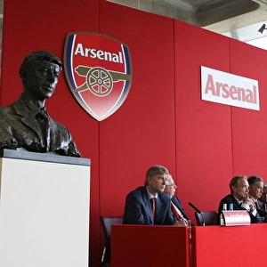 Arsene Wenger the Arsenal Manager seats next to his bust