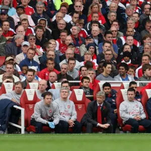 Arsene Wenger the Arsenal Manager seats in the dug