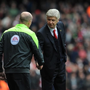 Arsene Wenger the Arsenal Manager shakes hands with Lee Mason the Fourth Official before the match