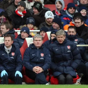 Arsene Wenger the Arsenal Manager sits on the bench with Pat Rice (Assistant Manager)