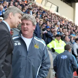 Arsene Wenger the Arsenal Manager speaks to Steve Bruce the Wigan Manager before the match Arsene Wenger the Arsenal Manager speaks to Steve Bruce the Wigan Manager before the match