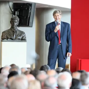 Arsene Wenger the Arsenal Manager stands next to the bust of himself