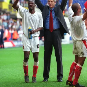 Arsene Wenger and Lauren celebrate at the end of the match