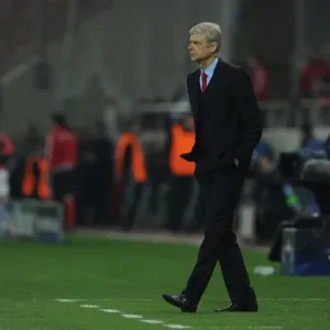 Arsene Wenger at Olympiacos vs Arsenal, UEFA Champions League 2015: A Tense Look from the Arsenal Manager's Bench in Athens Arsene Wenger at Olympiacos vs Arsenal, UEFA Champions League 2015: A Tense Look from the Arsenal Manager's Bench in Athens