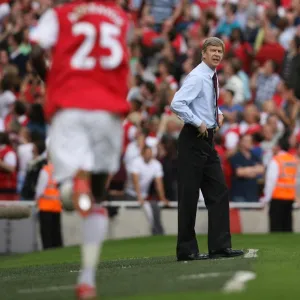 Arsene Wenger watches Emmanuel Adebayor celebrate scoring Arsenals 2nd goal his 1st