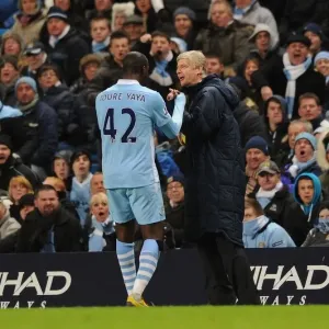 Arsene Wenger and Yaya Toure: A Light-Hearted Moment Amidst the Manchester City vs. Arsenal Rivalry (2011-12)