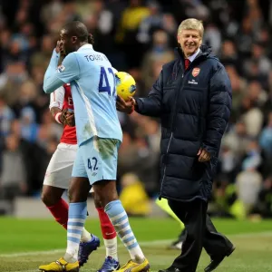 Arsene Wenger and Yaya Toure Share a Light-Hearted Moment Amidst Manchester City vs. Arsenal Rivalry (2011-12)
