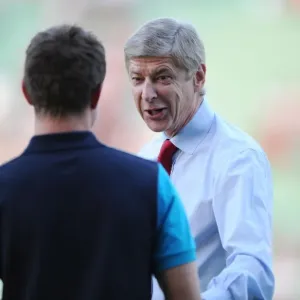 Arsene Wenger's Light-Hearted Moment with Aaron Ramsey during Udinese v Arsenal, UEFA Champions League Play-Off (2011) Arsene Wenger's Light-Hearted Moment with Aaron Ramsey during Udinese v Arsenal, UEFA Champions League Play-Off (2011)