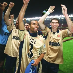 Ashley Cole and Martin Keown celebrate the Arsenal Championship victory after the match Ashley Cole and Martin Keown celebrate the Arsenal Championship victory after the match