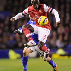 Battling Past: Sagna Outmaneuvers Pienaar in Everton vs Arsenal Clash (2012-13)