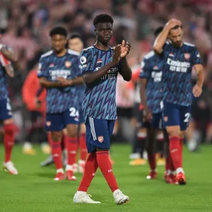 Bukayo Saka Celebrates with Arsenal Fans after Brentford Victory - 2021-22 Premier League Bukayo Saka Celebrates with Arsenal Fans after Brentford Victory - 2021-22 Premier League