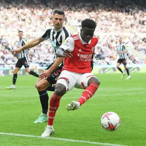 Bukayo Saka Faces Off Against Fabian Schaer: Intense Battle at St. James Park - Arsenal vs Newcastle United, Premier League 2022-23
