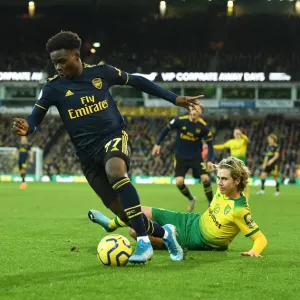 Bukayo Saka vs Todd Cantwell: Intense Battle at Carrow Road - Norwich City vs Arsenal FC, Premier League 2019-20 Bukayo Saka vs Todd Cantwell: Intense Battle at Carrow Road - Norwich City vs Arsenal FC, Premier League 2019-20