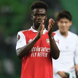 Bukayo Saka's Euphoric Moment: Arsenal's Victory Applause at Sporting Lisbon's Estadio Jose Alvalade - Arsenal's Triumph in the UEFA Europa League 2022-23 Round of 16 (Lisbon, Portugal - March 9, 2023)