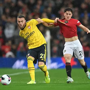 Calum Chambers Evades Daniel James: A Tense Moment from the Manchester United vs Arsenal Premier League Clash (2019-20)