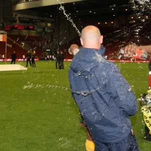 Captain Jay Thomas soaks Youth Team Coach Steve Bould after the match