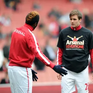 Carl Jenkinson and Alex Song (Arsenal) warm up in thier Arsenal for Everyone T Shirt