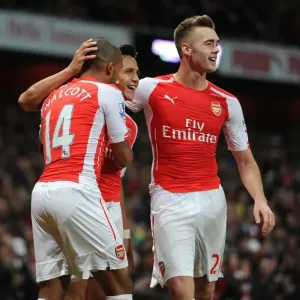 Celebrating Victory: Alexis Sanchez, Theo Walcott, and Calum Chambers Celebrating Victory: Alexis Sanchez, Theo Walcott, and Calum Chambers