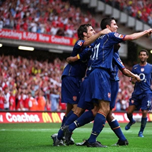 Cesc Fabrages and Robin van Persie celebrate Arsenal 3rd gaol with Goalscorer Ashley Cole