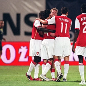 Cesc Fabregas celebrates scorong the 3rd Arsenal goal with Alex Hleb
