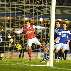Cesc Fabregas looks on as his shot is put inot his own net by Birmingham defender Roger Johnson