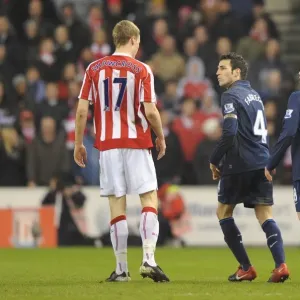 Cesc Fabregas and Samir Nasri (Arsenal) clash with Ryan Shawcross (Stoke)
