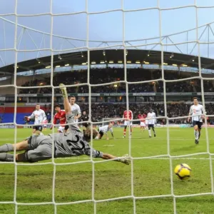 Cesc Fabregas shoots past Bolton goalkeeper Jussi Jskelainen to score the 1st Arsenal goal