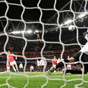 Cesc Fabregas shoots past Shakhtar goalkeeper Andriy Pyatov score the 3rd Arsenal goal