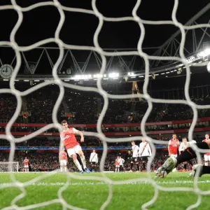 Cesc Fabregas shoots past Shakhtar goalkeeper Andriy Pyatov score the 3rd Arsenal goal