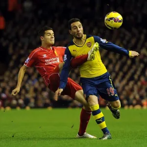 Clash at Anfield: Cazorla vs. Coutinho in the 2014/15 Premier League Battle between Liverpool and Arsenal Clash at Anfield: Cazorla vs. Coutinho in the 2014/15 Premier League Battle between Liverpool and Arsenal